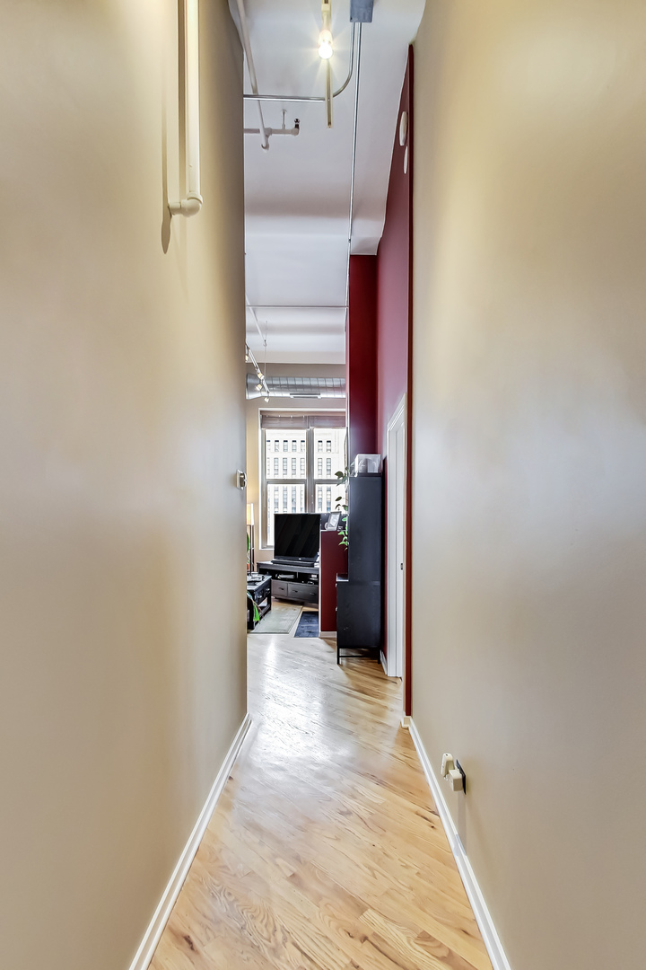 500 South Clinton Street, Unit 810 Chicago, IL 60607 - Photo 15 of 54 a view of a hallway with wooden shelves