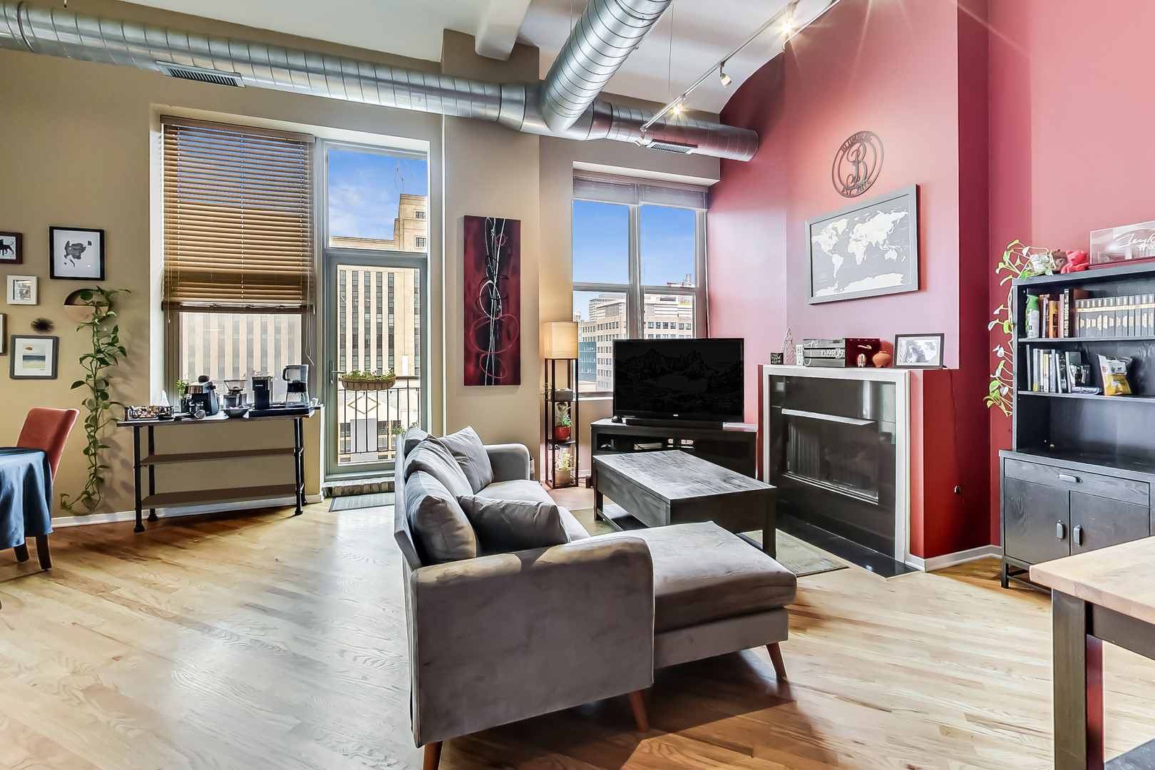 500 South Clinton Street, Unit 810 Chicago, IL 60607 - Photo 19 of 54 a living room with furniture a flat screen tv and a fireplace