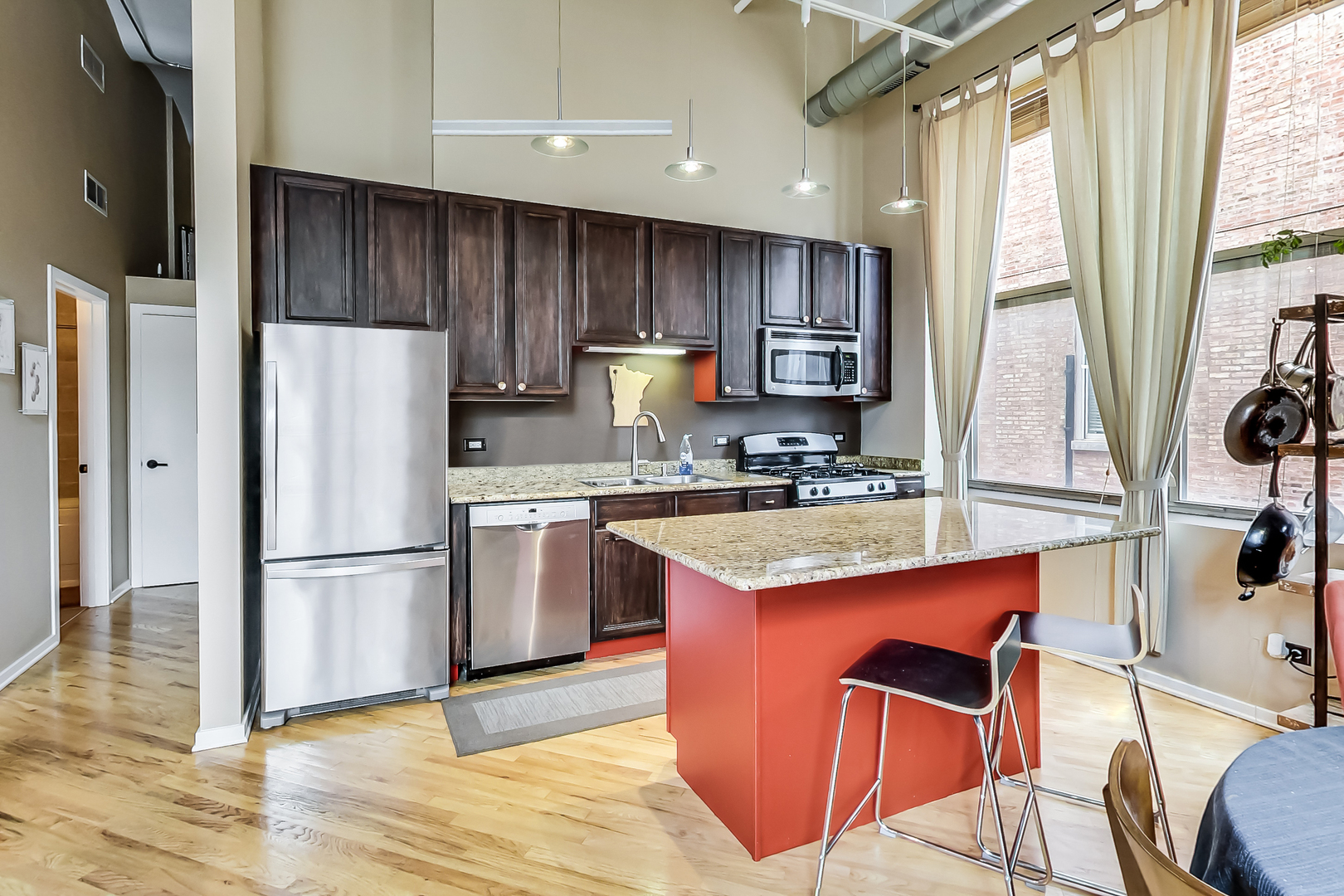 500 South Clinton Street, Unit 810 Chicago, IL 60607 - Photo 23 of 54 a kitchen with stainless steel appliances granite countertop a refrigerator a sink dishwasher and a stove with wooden floor