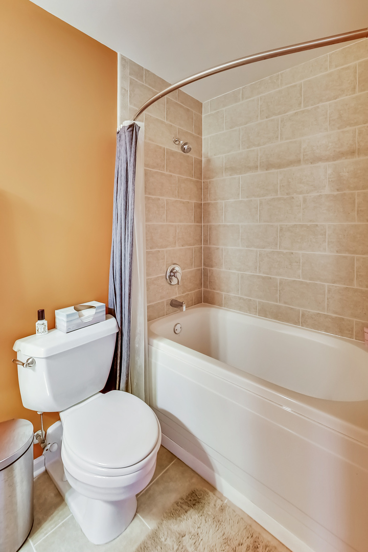 500 South Clinton Street, Unit 810 Chicago, IL 60607 - Photo 31 of 54 a white toilet sitting next to a bath tub and a shower