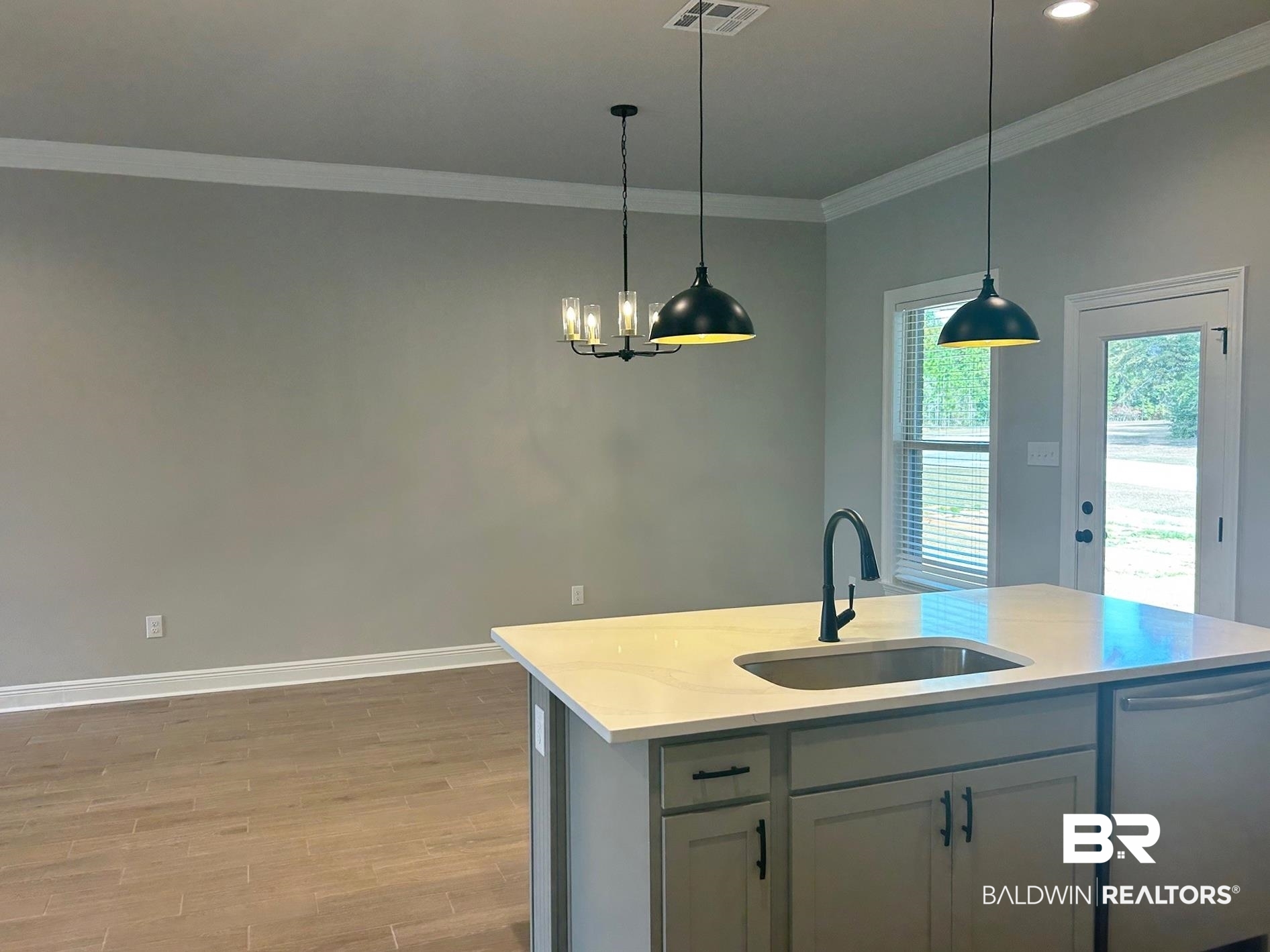 808 Sumter Loop Foley, AL 36535 - Photo 4 of 18 Kitchen with dishwasher, sink, light hardwood / wood-style flooring, pendant lighting, and a center island with sink