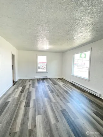 wooden floor in an empty room with a window