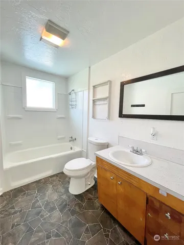 a bathroom with a sink a toilet and a bathtub