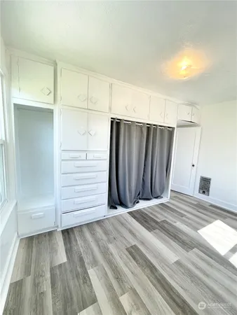a view of a closet with wooden floor