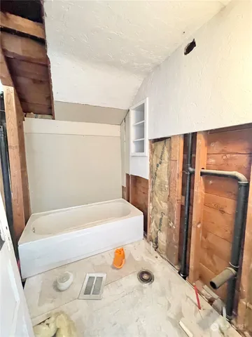 a bathroom with a tub and shower