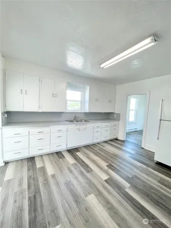 a view of a kitchen with wooden floor