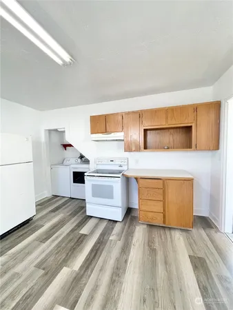 a kitchen with stainless steel appliances a stove top oven and refrigerator