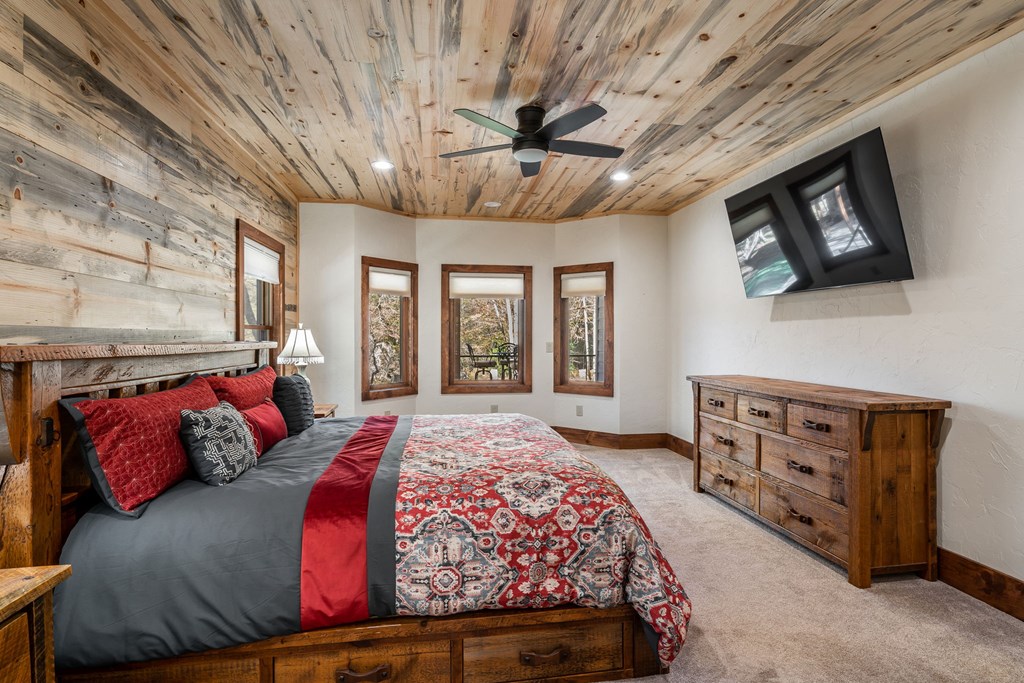 1248 Sunset Road Epworth, GA 30541 - Photo 19 of 65 a bedroom with a large bed and a tv