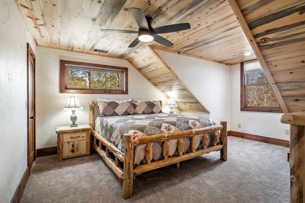 1248 Sunset Road Epworth, GA 30541 - Photo 30 of 65 a spacious bedroom with a bed and a window