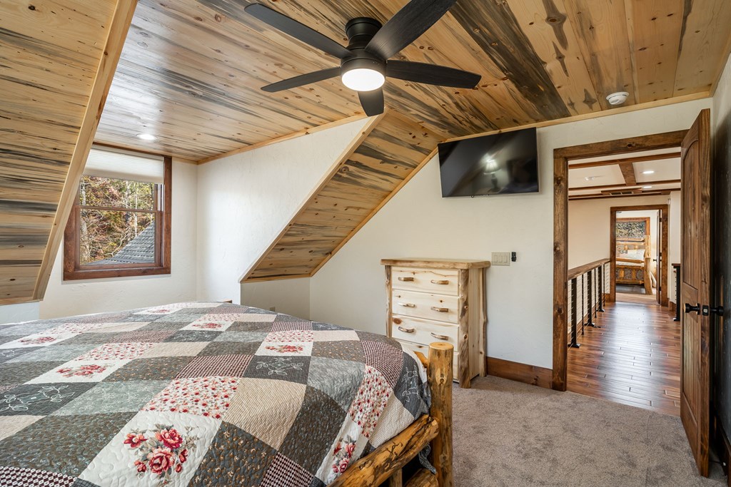 1248 Sunset Road Epworth, GA 30541 - Photo 31 of 65 a bedroom with a bed a dresser and book shelf