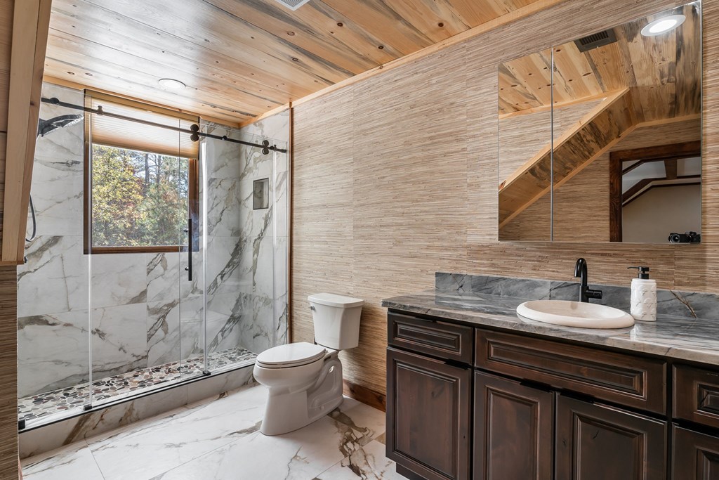 1248 Sunset Road Epworth, GA 30541 - Photo 41 of 65 a bathroom with a granite countertop sink toilet and shower