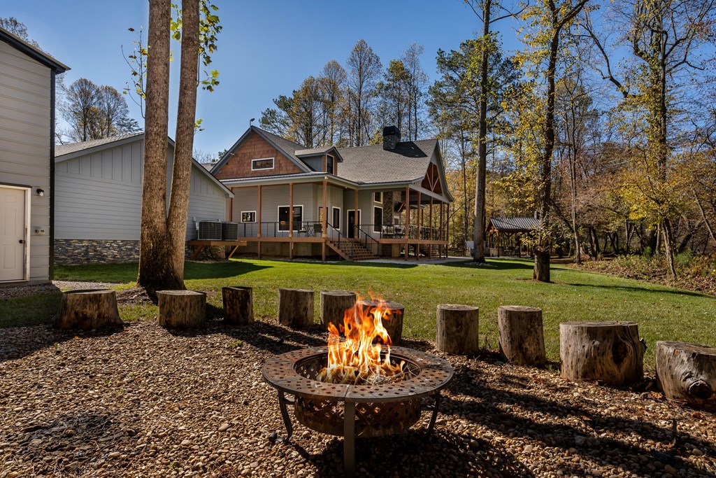 1248 Sunset Road Epworth, GA 30541 - Photo 48 of 65 a view of a house with backyard sitting area and garden