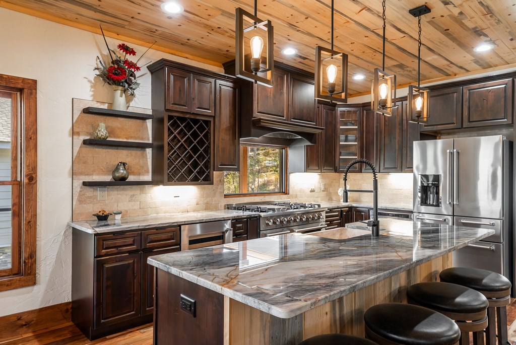 1248 Sunset Road Epworth, GA 30541 - Photo 7 of 65 a kitchen with stainless steel appliances granite countertop a sink a stove and a wooden cabinets