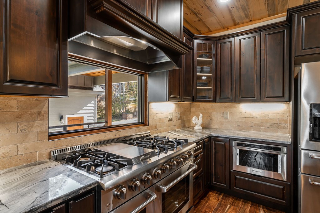 1248 Sunset Road Epworth, GA 30541 - Photo 9 of 65 a kitchen with granite countertop stainless steel appliances and wooden cabinets