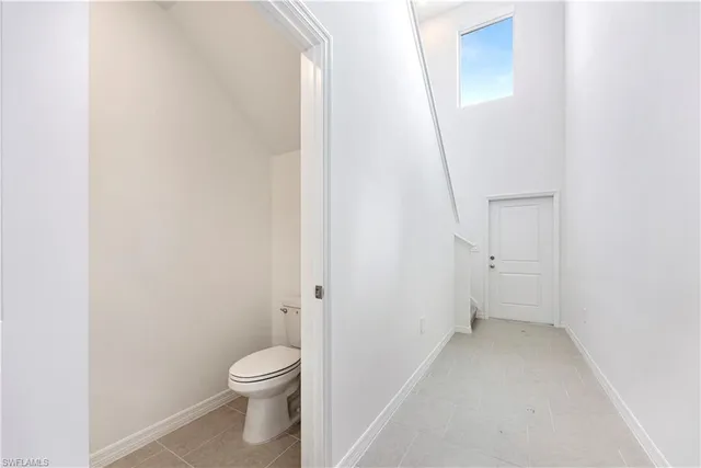 a bathroom with a granite countertop toilet and a shower