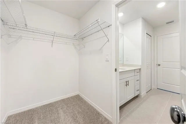 a view of walk in closet with white walls
