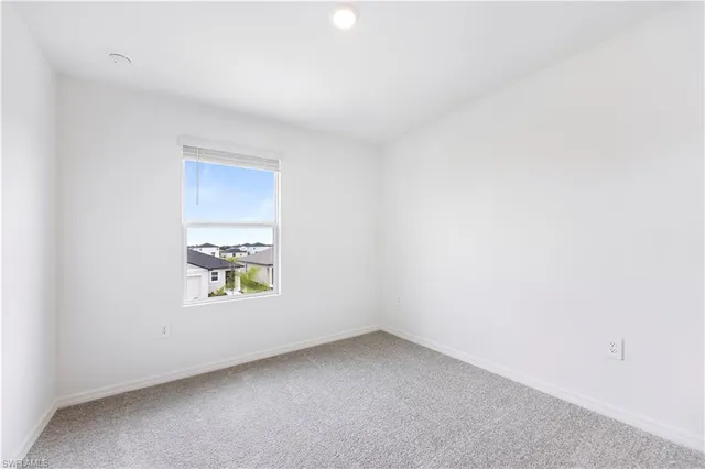 an empty room with a empty space and windows