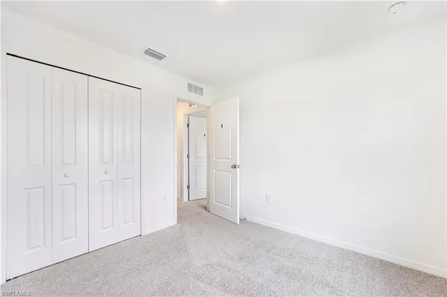 a view of a hallway with wooden shelves