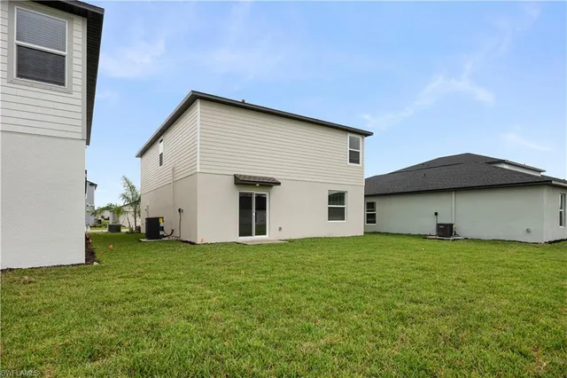 an aerial view of a house with garden space and lake view