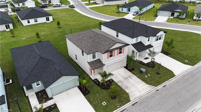 an aerial view of multiple houses with yard