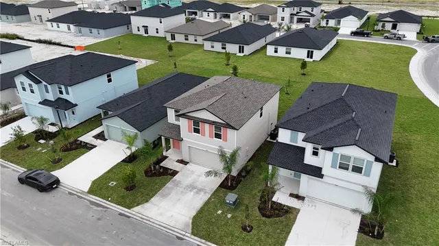 an aerial view of a house with garden space and street view
