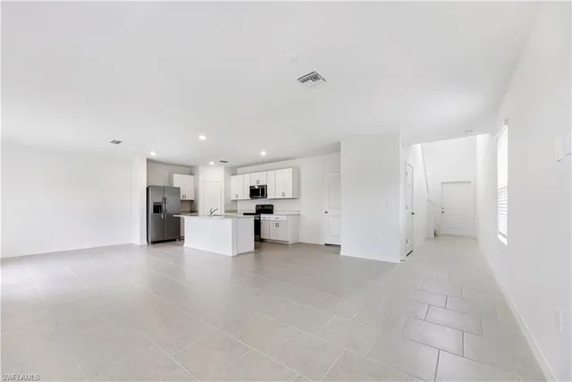 a view of a kitchen with a sink and a refrigerator