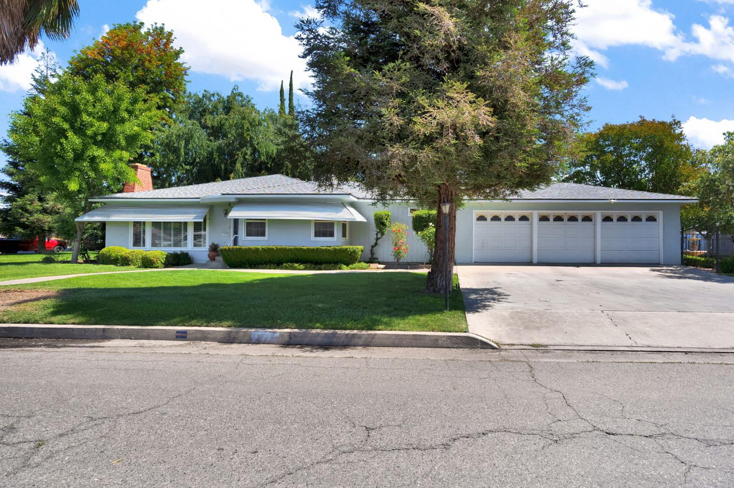 200 Lyons Street Madera, CA 93638 - Photo 1 of 32 a front view of a house with a yard