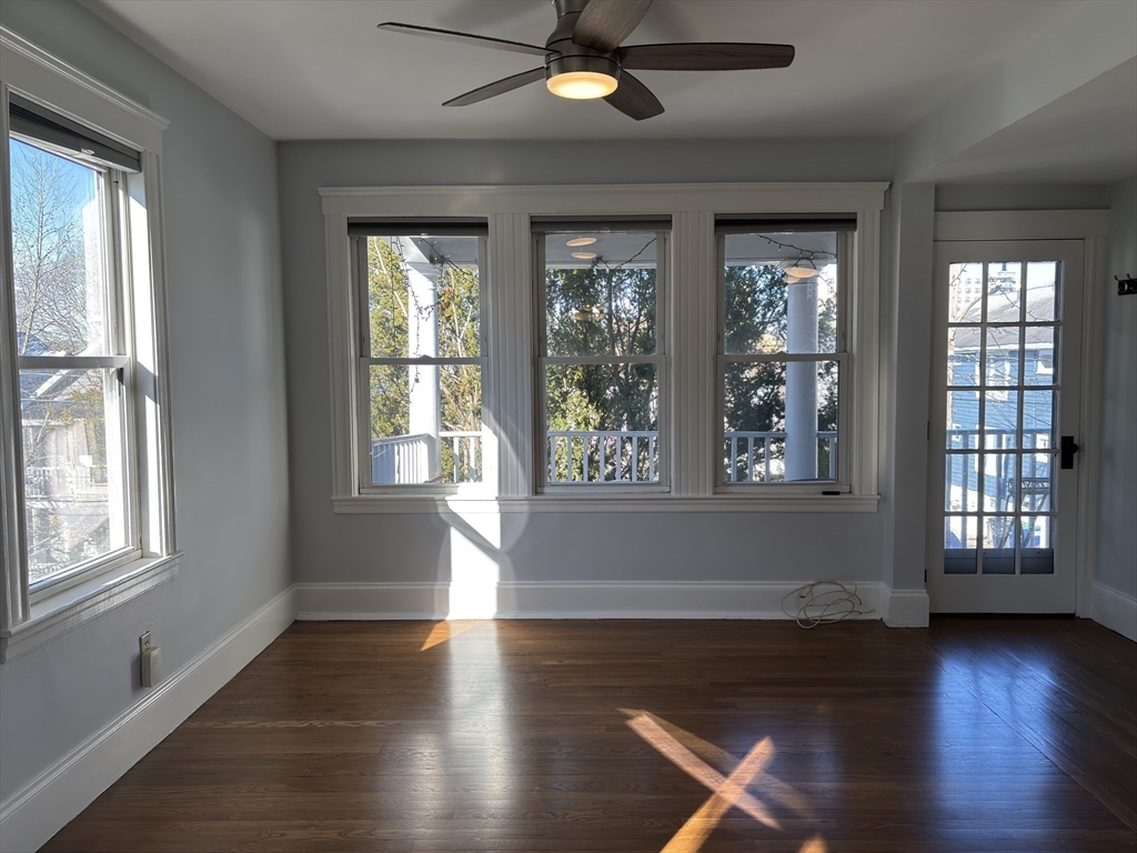 54-56 Farragut Avenue, Unit 2 Somerville, MA 02144 - Photo 1 of 30 a view of an empty room with wooden floor and a window