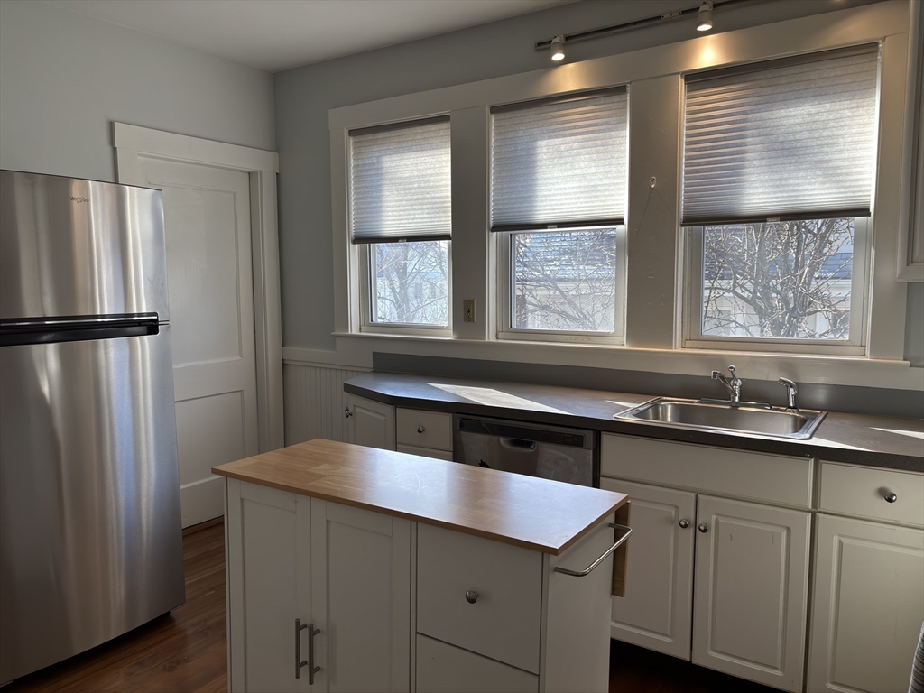 54-56 Farragut Avenue, Unit 2 Somerville, MA 02144 - Photo 11 of 30 a kitchen with a sink a refrigerator and window
