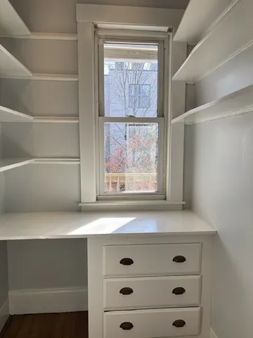 a view of white cabinets and a window