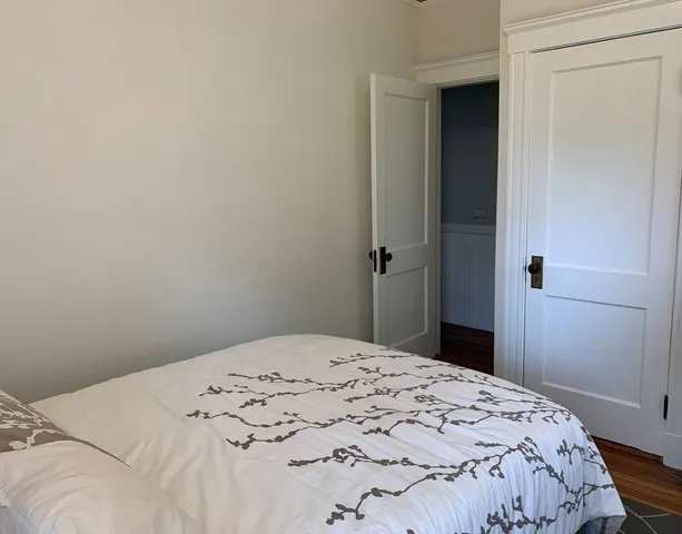 a bedroom with a bed and a mirror