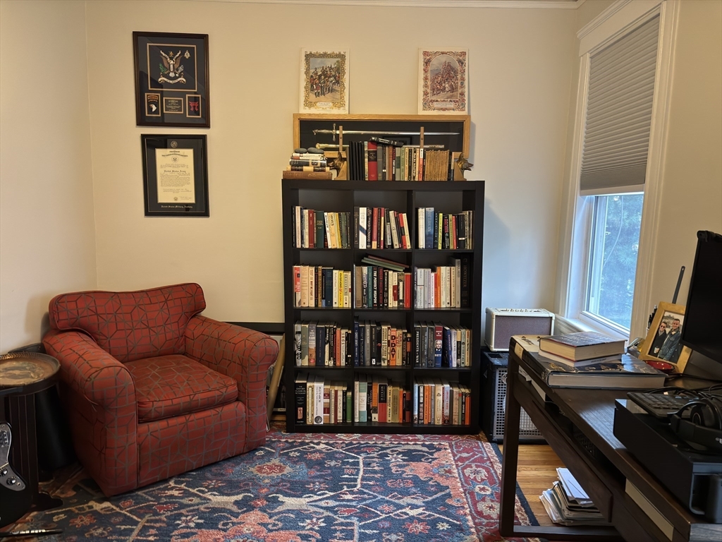 54-56 Farragut Avenue, Unit 2 Somerville, MA 02144 - Photo 18 of 30 a living room with furniture and a book shelf
