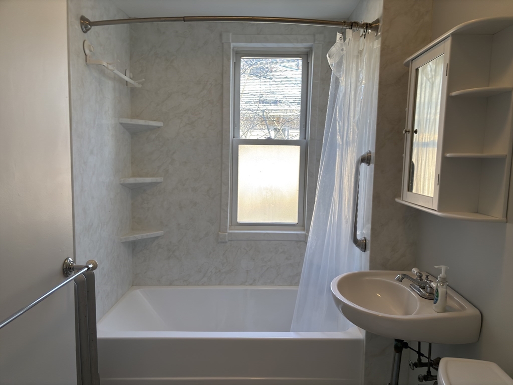 54-56 Farragut Avenue, Unit 2 Somerville, MA 02144 - Photo 22 of 30 a bathroom with a sink and a bathtub