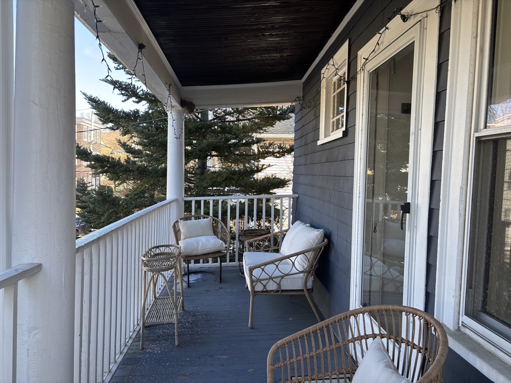 54-56 Farragut Avenue, Unit 2 Somerville, MA 02144 - Photo 23 of 30 a view of a chair and table in the balcony