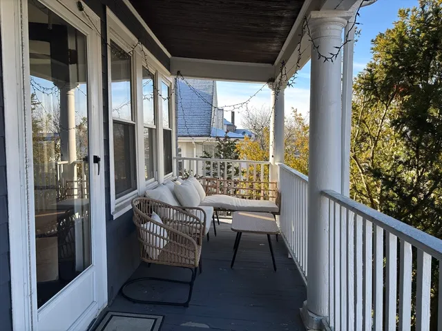 a view of balcony with a potted plant and a glass door
