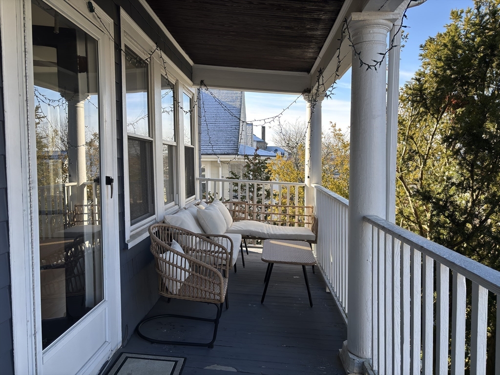 54-56 Farragut Avenue, Unit 2 Somerville, MA 02144 - Photo 24 of 30 a view of balcony with a potted plant and a glass door