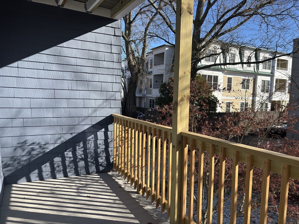 54-56 Farragut Avenue, Unit 2 Somerville, MA 02144 - Photo 25 of 30 a view of a brick building from a balcony