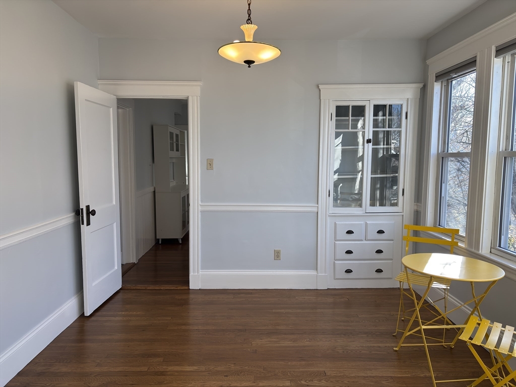 54-56 Farragut Avenue, Unit 2 Somerville, MA 02144 - Photo 6 of 30 wooden floor in an empty room with a window