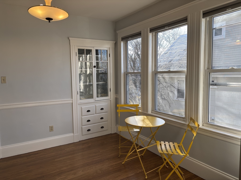 54-56 Farragut Avenue, Unit 2 Somerville, MA 02144 - Photo 7 of 30 a living room with a table and a chair