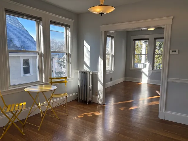 a view of an entryway with wooden floor and a window