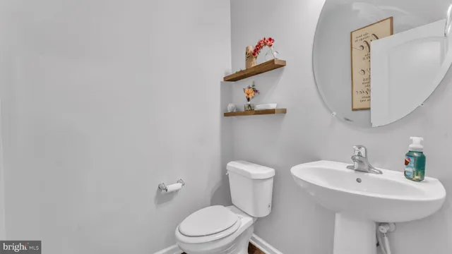 a white toilet sitting next to a bathroom sink