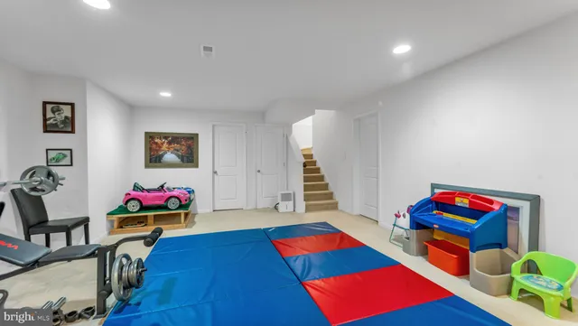 a living room with furniture and a gym equipment