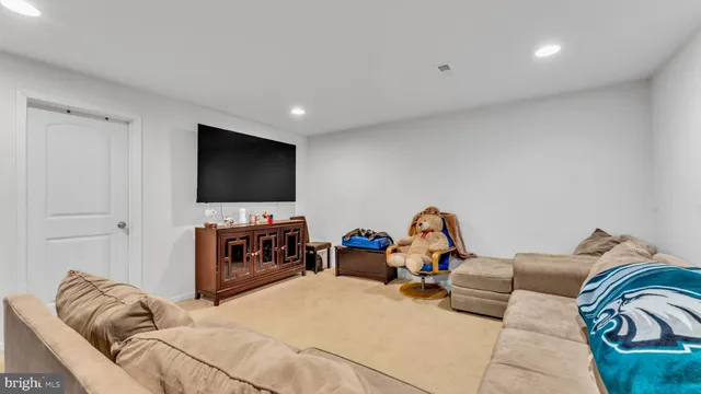 a bedroom with furniture and a flat screen tv