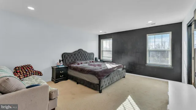 a bedroom with a large bed and a lamp