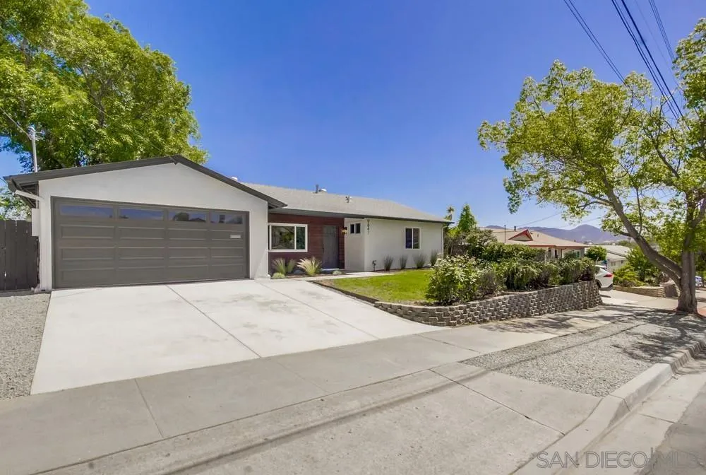 9841 Settle Road Santee, CA 92071 - Photo 2 of 46 a front view of a house with a yard and garage
