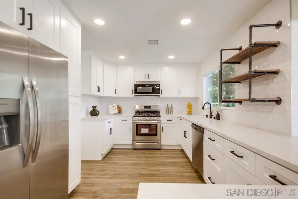 9841 Settle Road Santee, CA 92071 - Photo 23 of 46 a kitchen with stainless steel appliances granite countertop a refrigerator a stove and a sink