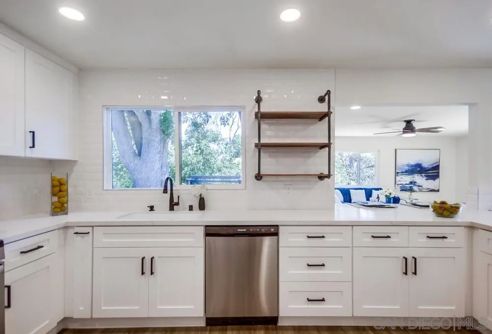 9841 Settle Road Santee, CA 92071 - Photo 26 of 46 a kitchen with white cabinets and window