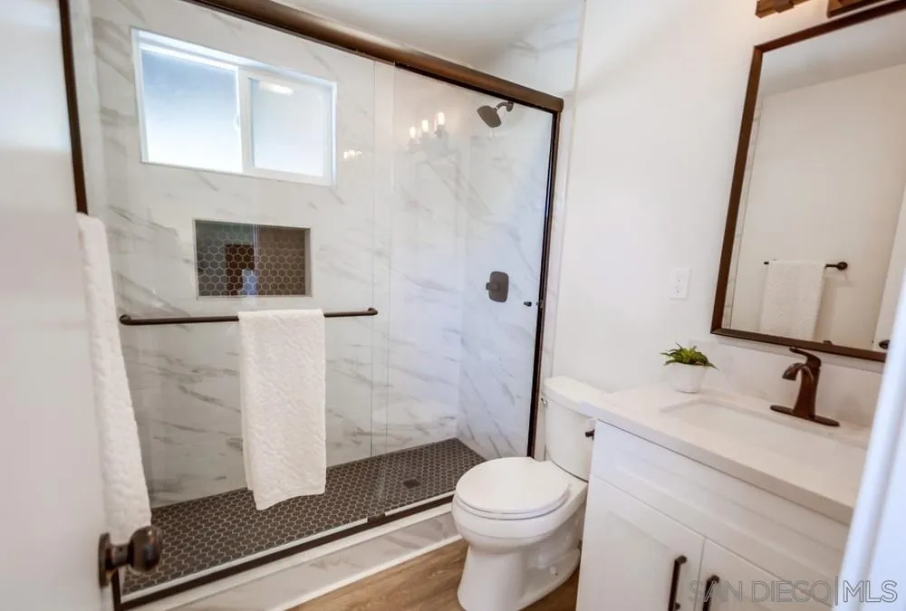 9841 Settle Road Santee, CA 92071 - Photo 31 of 46 a bathroom with a sink toilet and shower