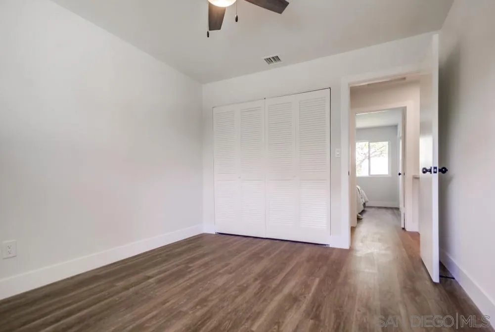 9841 Settle Road Santee, CA 92071 - Photo 34 of 46 an empty room with wooden floor and a ceiling fan