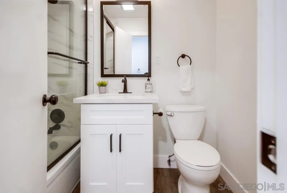 9841 Settle Road Santee, CA 92071 - Photo 36 of 46 a bathroom with a toilet sink and mirror